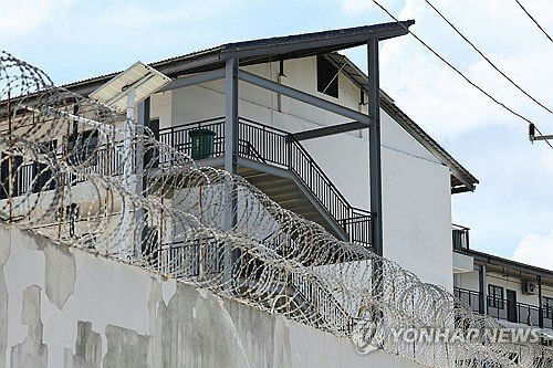 security-A-barbed wire-A-prison-A-building-A-railing