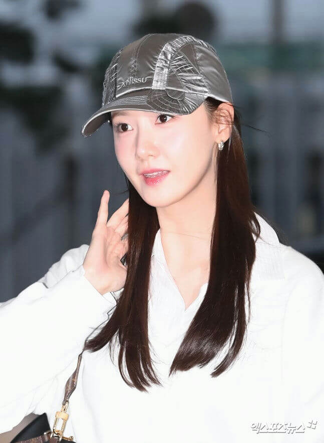 people-woman-A-silver baseball cap-B-long dark hair-C-white shirt