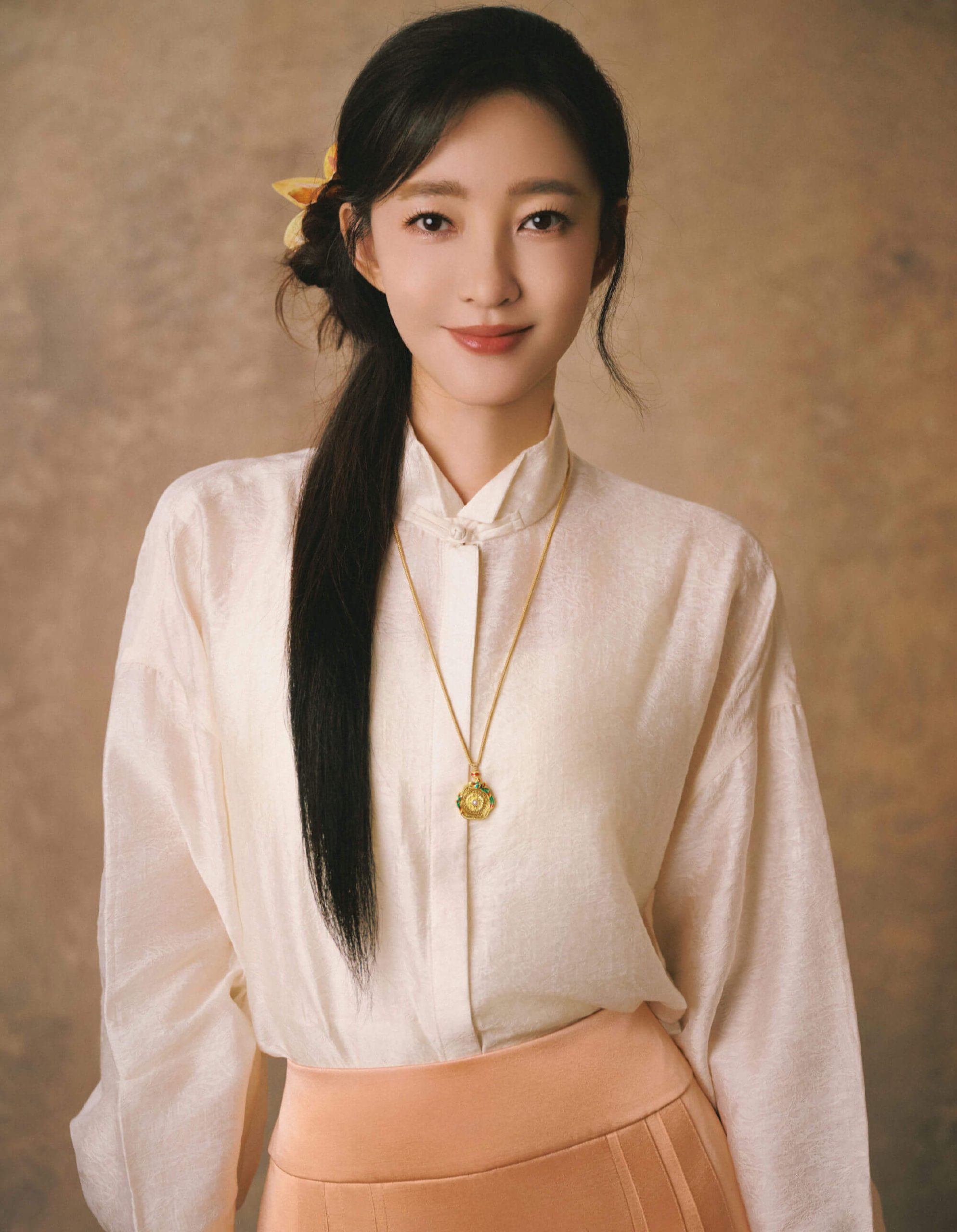 people-woman-elegant-A-traditional collar shirt-A-long dark hair-A-gold necklace-A-peach skirt