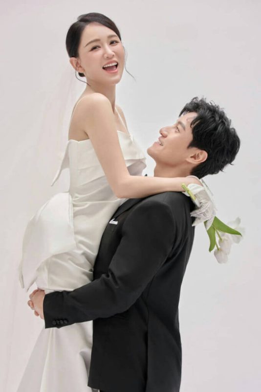 people-A-bride-A-groom-A-wedding-dress-B-suit-B-holding-B-flowers-C-smiling-C-joyful