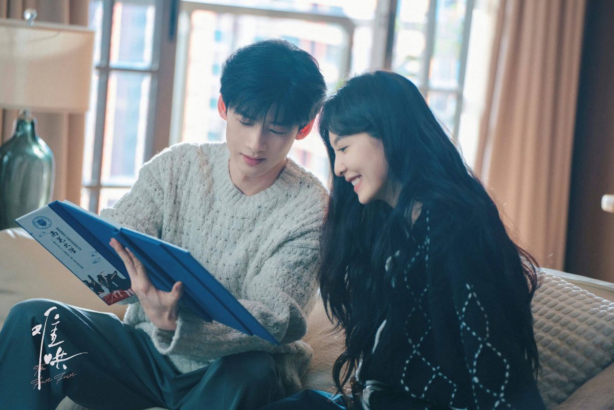 people-A-young man-A-young woman-A-couple-B-looking at book-B-smiling-C-cozy indoor setting