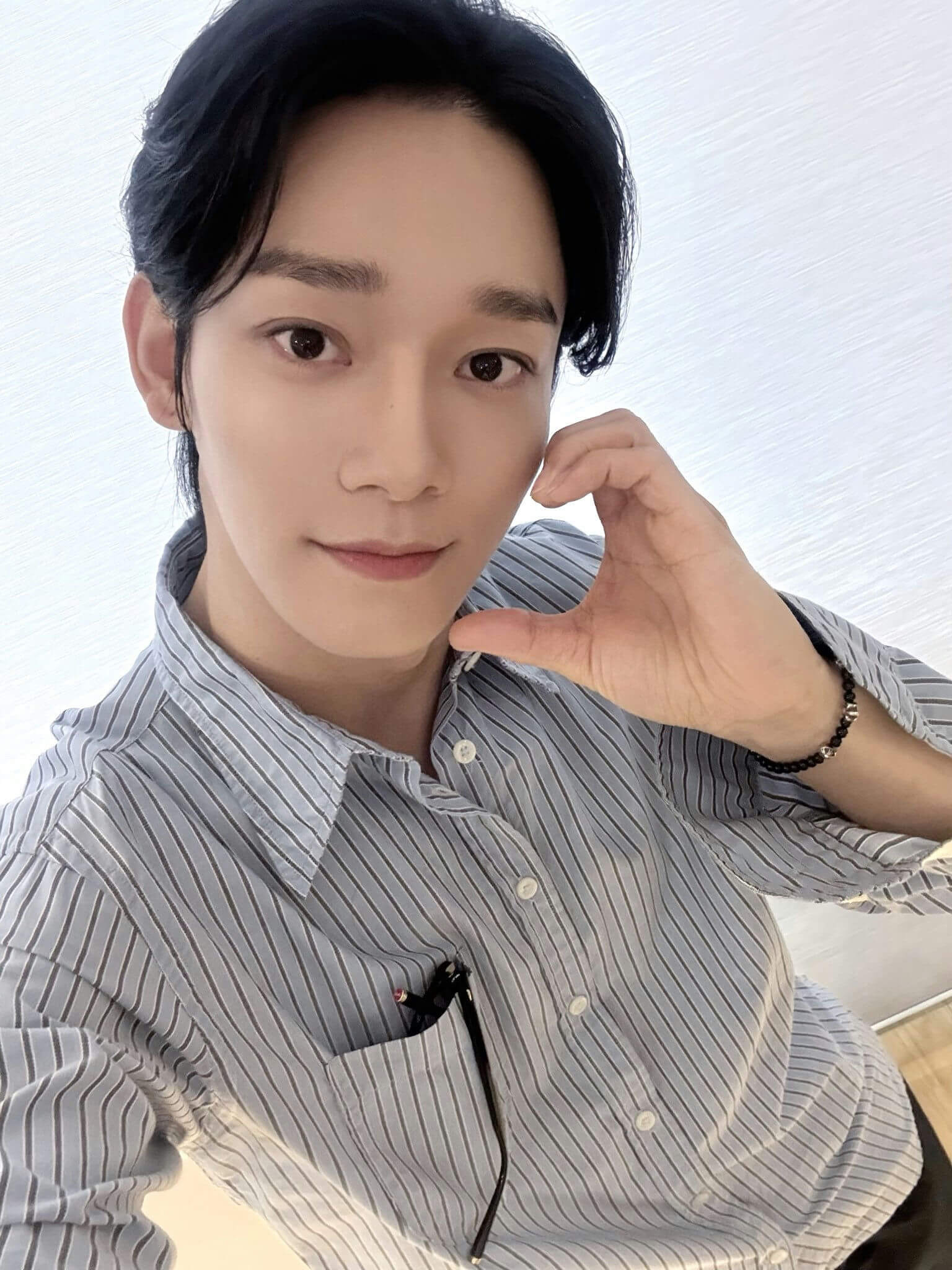 people-one male-A-selfie-A-striped button-up shirt-A-hand heart gesture