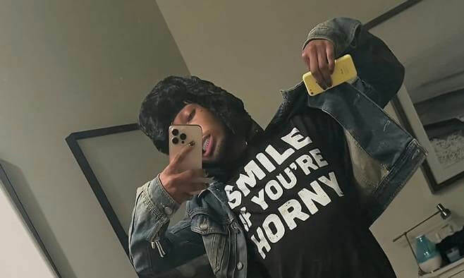 people-1-mirror-selfie-A-person-A-black-fur-hat-B-graphic-t-shirt-C-denim-jacket