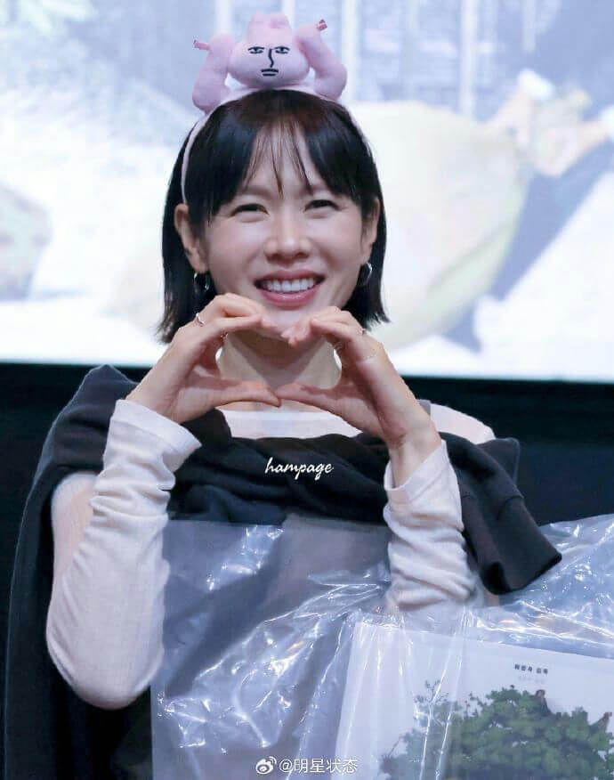 people-Woman-Smiling-A-Heart-Gesture-A-Pink-Headband-A-Short-Black-Hair