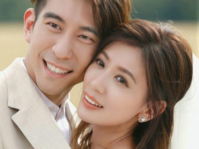 people-A-couple-A-wedding-attire-A-smiling-A-outdoor-portrait