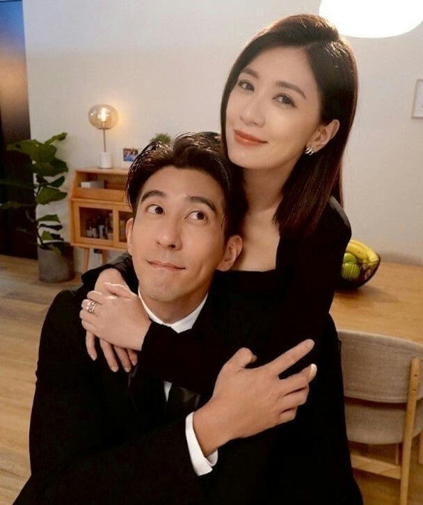 people-A-man in black suit-A-woman hugging man-B-smiling woman-B-man looking up-C-couple-C-indoor setting