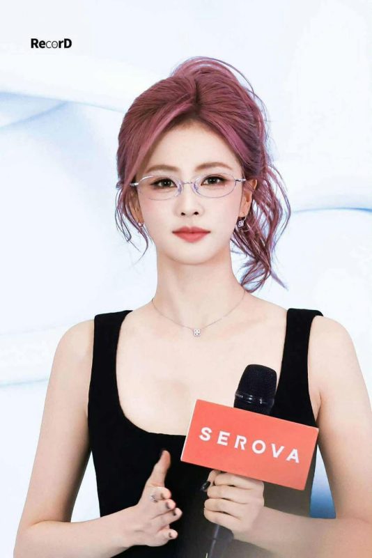 people-woman-pink hair-wearing glasses-black tank top-holding microphone-SEROVA logo