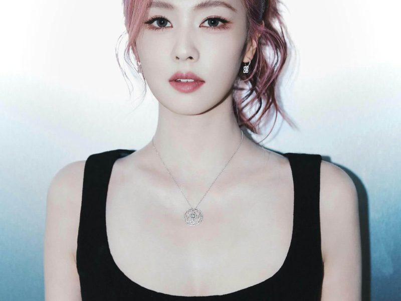 people-woman-pink hair-black tank top-silver necklace-glasses on head-silver earrings