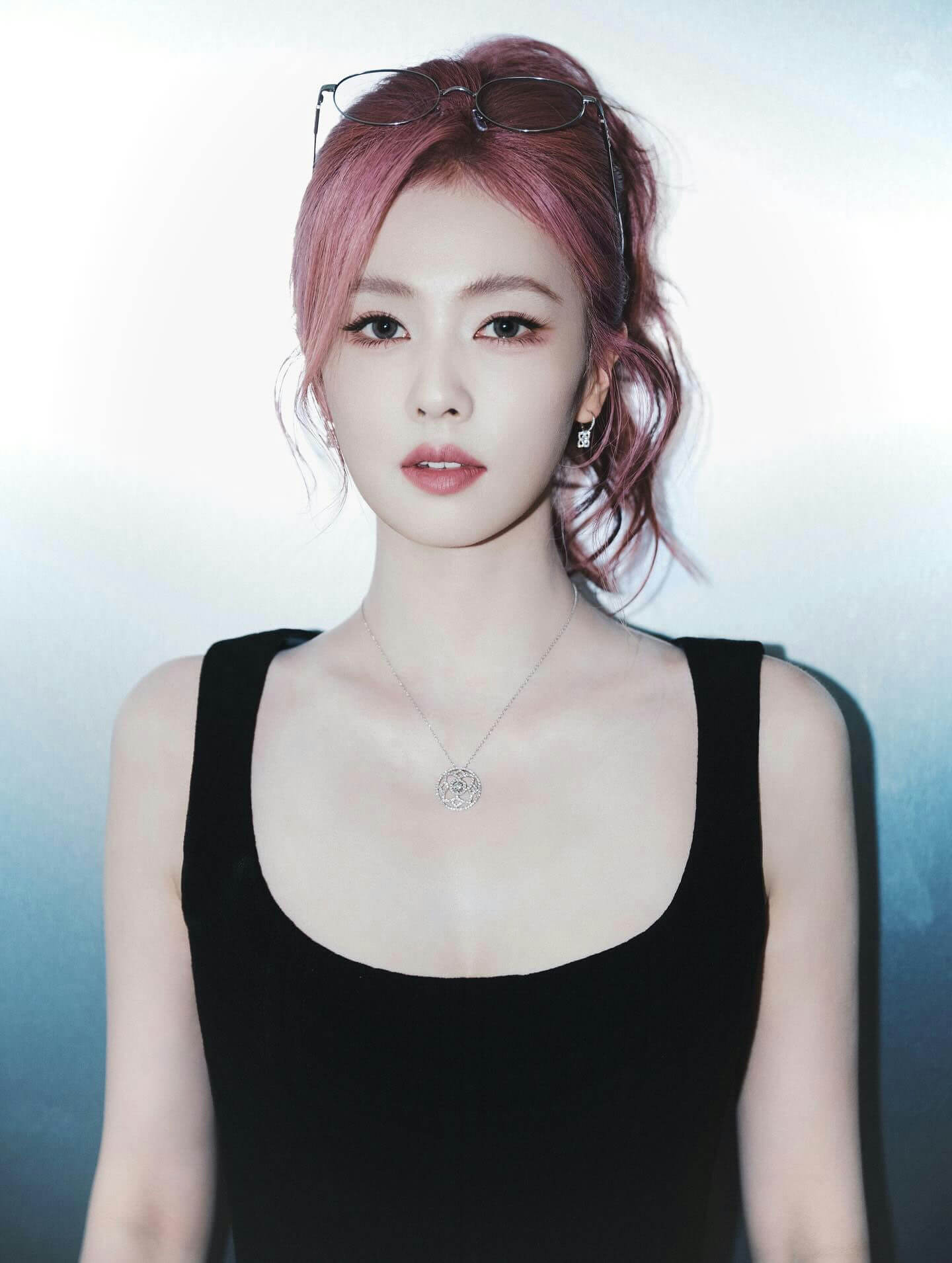 people-woman-pink hair-black tank top-silver necklace-glasses on head-silver earrings