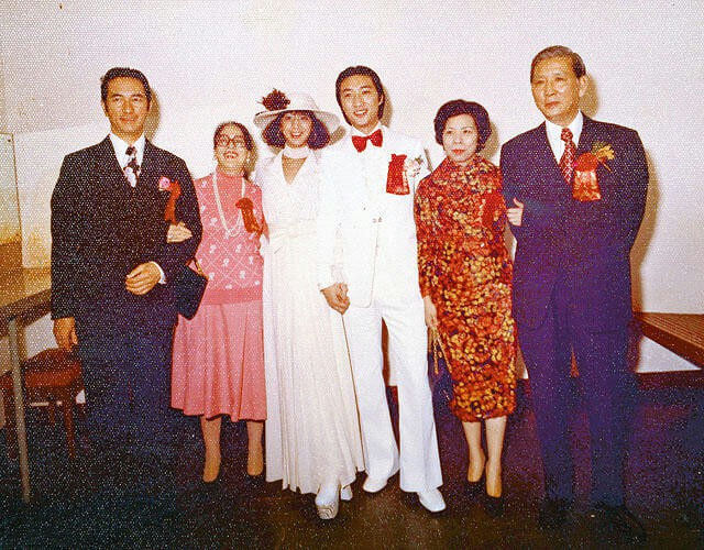 people-6-wedding-A-formal-attire-A-1970s-or-1980s-fashion-A-Asian-individuals-A-bride-and-groom-A-family-portrait-B-white-suit-B-red-dress-B-dark-suits-B-pink-outfit-C