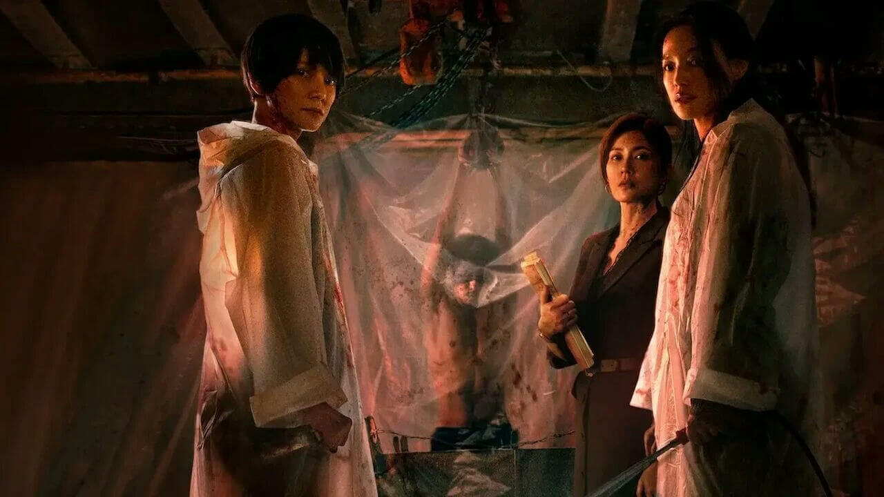 people-three women-A-dark setting-A-plastic sheeting-B-blood stains-B-hooded garments-C-middle woman holding object-C