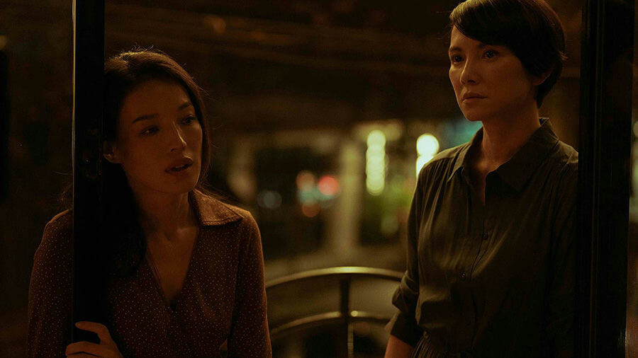 people-Two Asian women-A-night-A-dark lighting-A-intense gaze-B-brown polka dot top-B-short dark hair-C-cinematic still