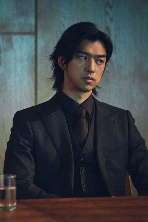 people-man-A-suit-A-dark-A-long hair-B-serious expression-C