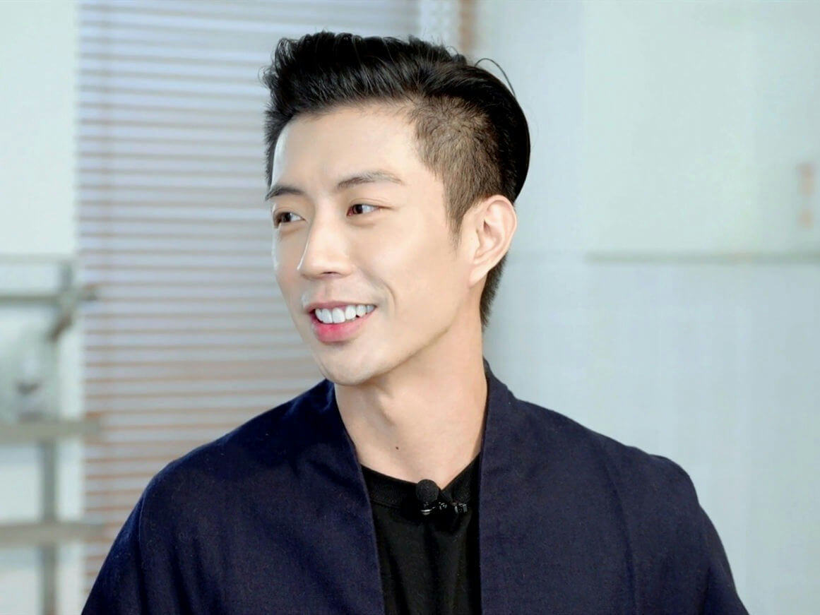people-man-smiling-dark hair-undercut-navy jacket-lapel microphone