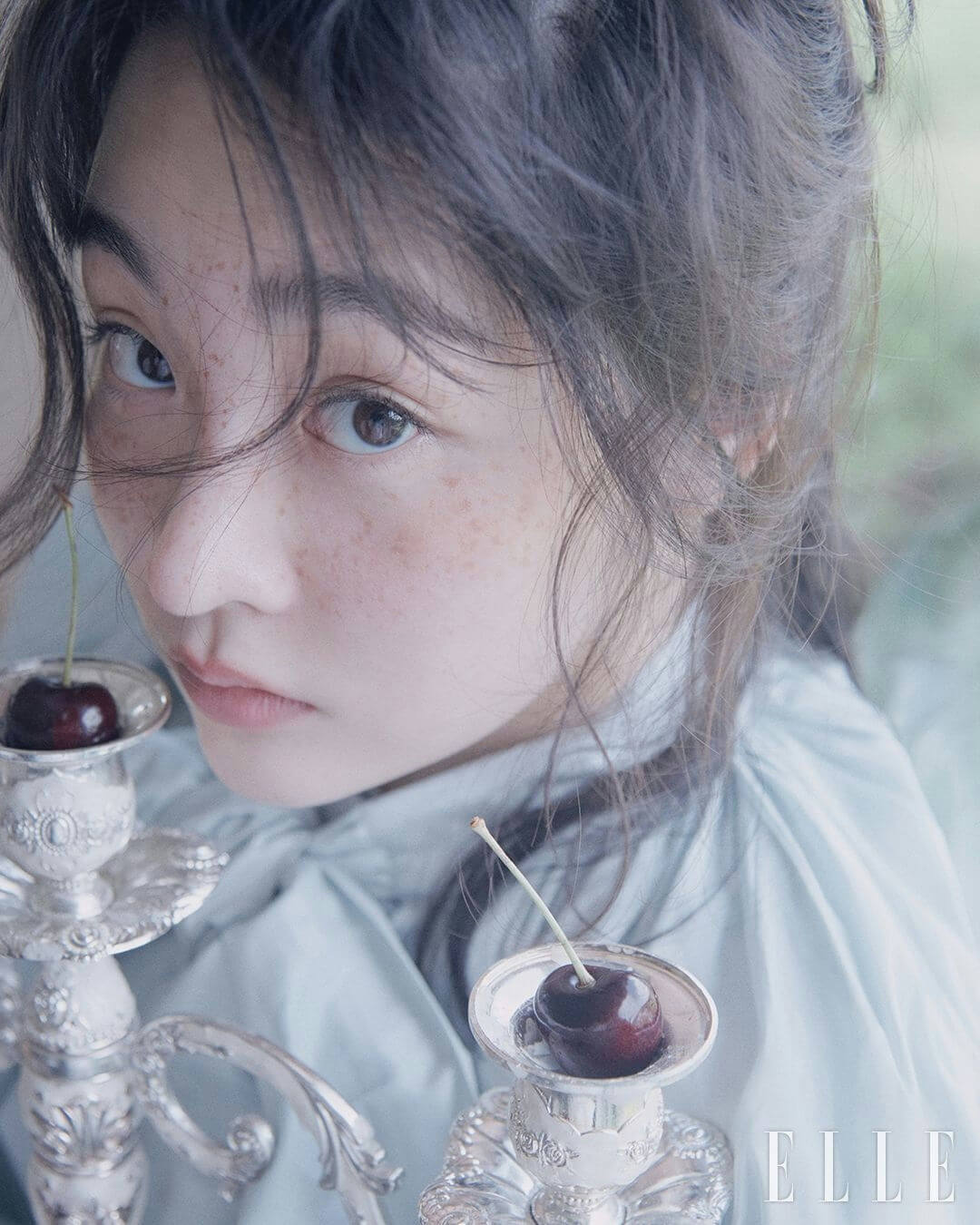 people-A-woman-A-freckles-B-cherries-C-silver-candelabra