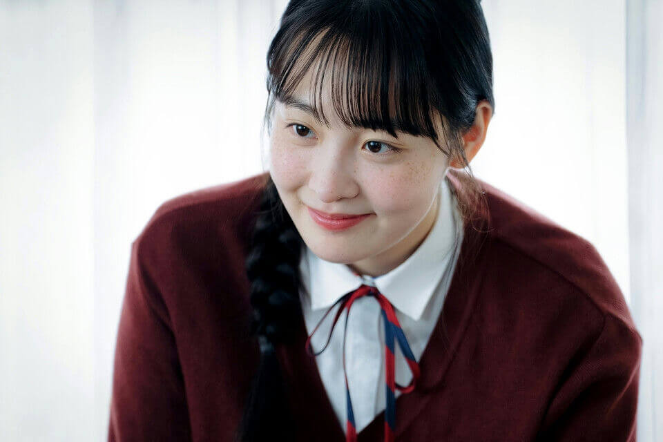 people-young woman-A-school uniform-A-braid-A-freckles-A-smiling