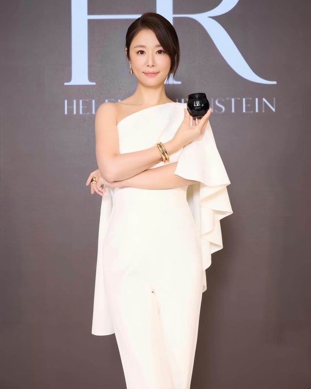 people-A-woman-A-white outfit-A-holding jar-A-Helena Rubinstein branding