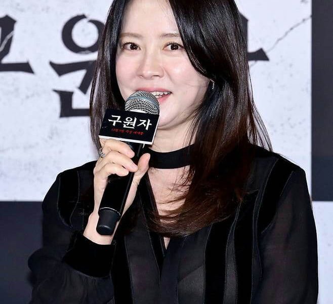 people-woman-A-speaking into microphone-B-black sheer blouse-C-Korean text on microphone flag