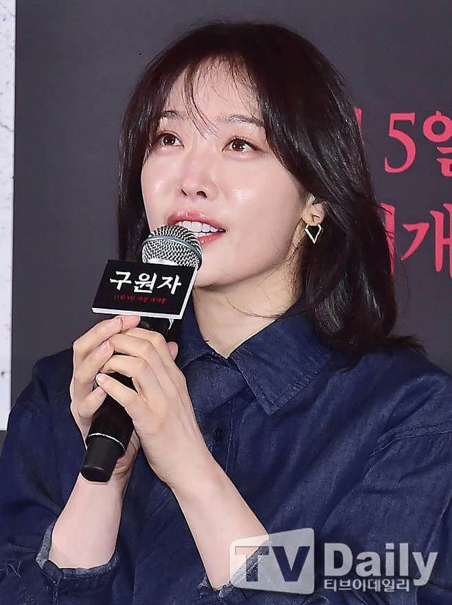 people-South Korean actress Han Ji-min-speaking into a microphone-at a promotional event-wearing a dark denim shirt-with small diamond-shaped earrings