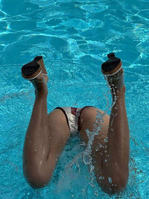 people-woman-A-legs-A-in-A-pool-A-wearing-A-swimsuit-A-wearing-A-heeled-shoes