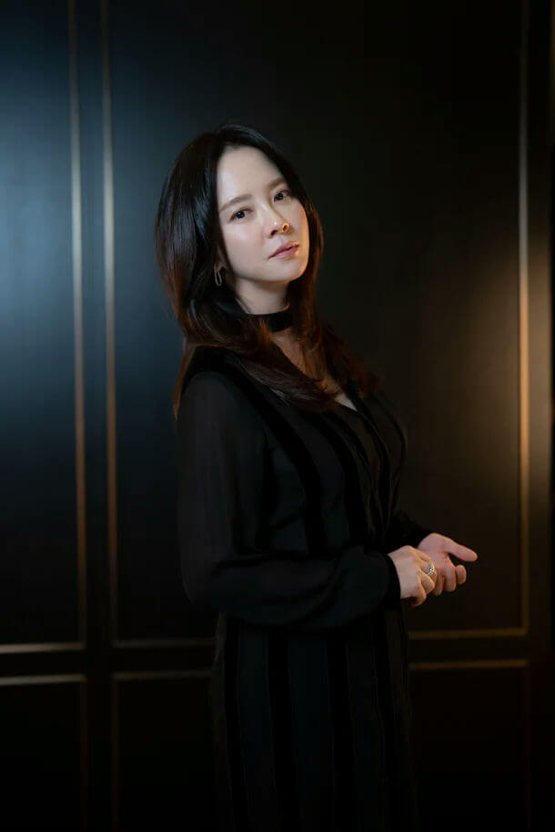 people-woman-A-dark attire-A-black dress-A-choker necklace-A-ring-A-dark background