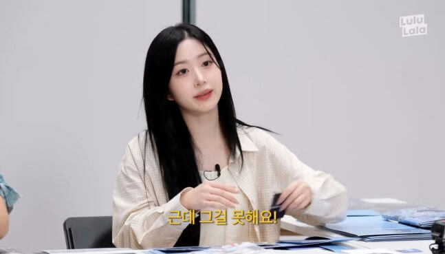 people-woman-long black hair-woman-light-colored patterned shirt-woman-speaking in interview-woman-holding small dark object