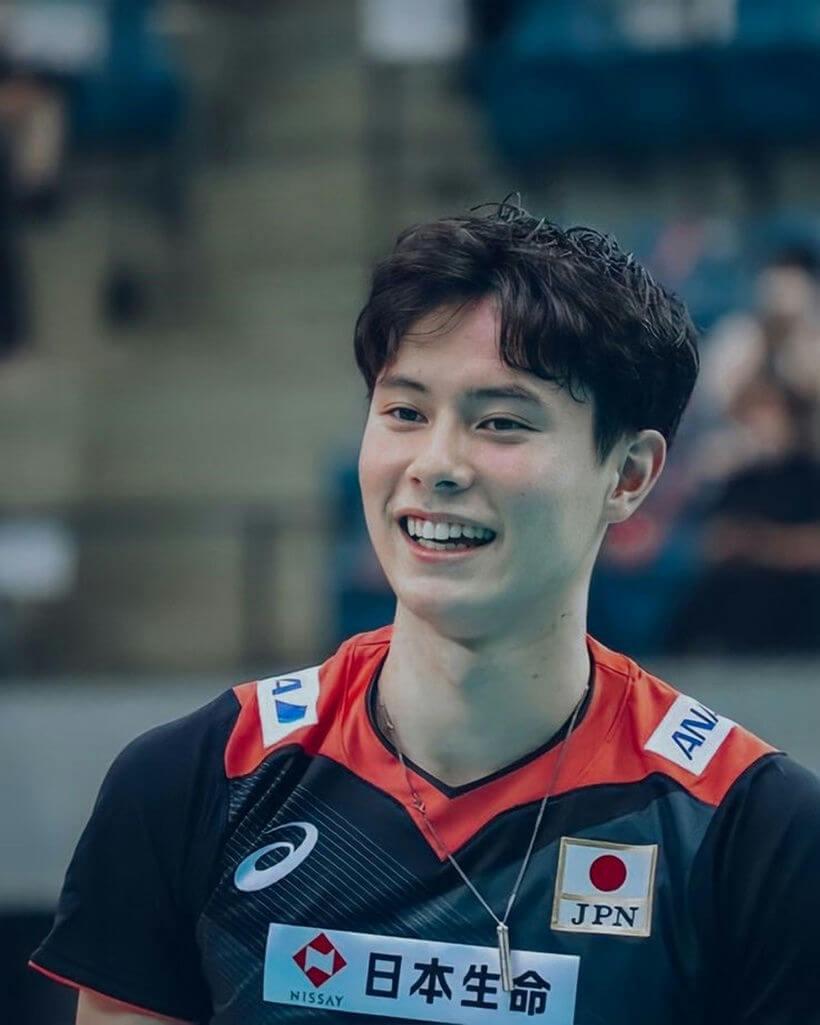 people-Japanese male volleyball player-smiling-wearing jersey-with Japanese flag patch-Nissay sponsor