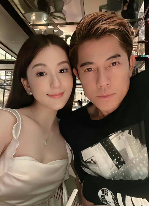 people-woman and man-couple selfie-woman smiling-man with dyed hair-indoor setting-formal attire (woman)