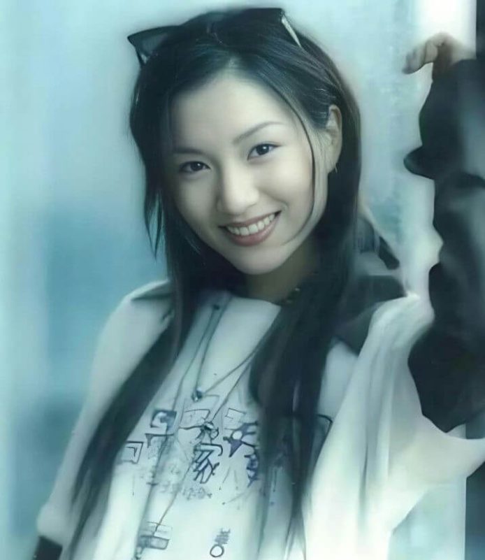 people-A-Asian woman-A-smiling-A-long dark hair-A-sunglasses on head-A-casual clothing-A-light blue tint