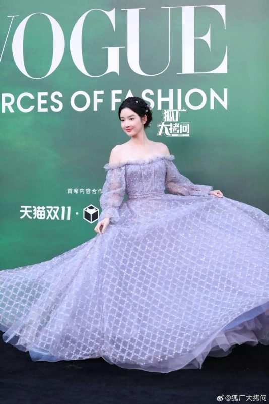 people-female celebrity-A-lavender gown-B-off-the-shoulder-C-Vogue event background
