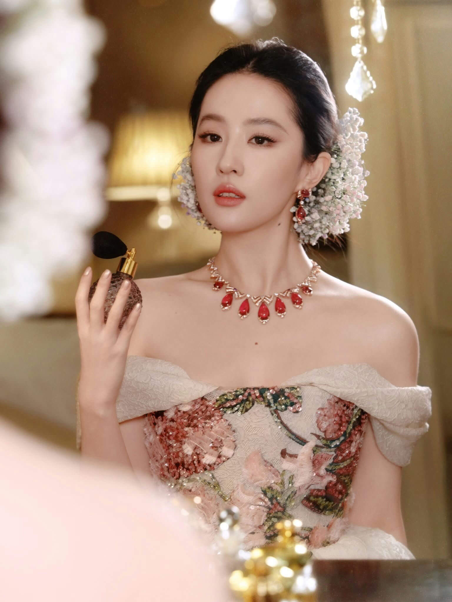 people-Liu Yifei-A-perfume bottle-A-off-the-shoulder floral gown-A-ruby jewelry-A-baby's breath flowers in hair