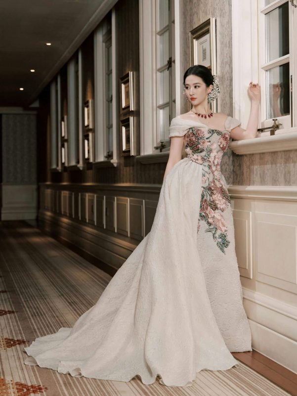 people-woman-A-elegant gown-B-floral embroidery-C-interior hallway
