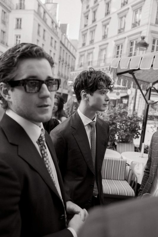 people-Two-young-men-A-suit-A-sunglasses-B-outdoor-cafe-B-black-and-white-C
