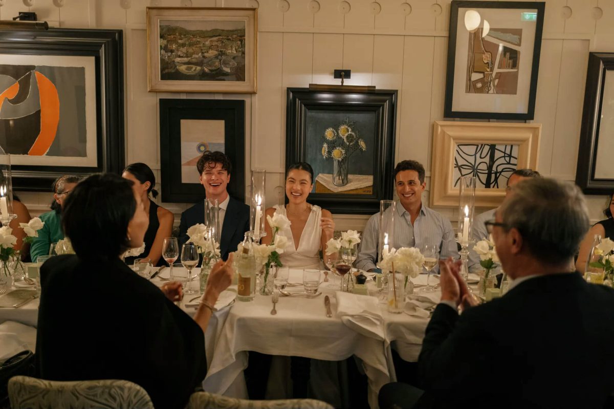 people-Group dining-A-Smiling-B-White flowers-C-Art on wall