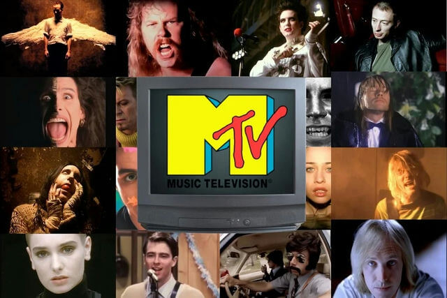 people-Michael Stipe-A-screaming-A-R.E. album era-B-James Hetfield-B-yelling-C-Annie Lennox-C-dramatic makeup-D-Dave Gahan-D-close up-E-Dave Mustaine-E-shouting-F-Jarvis Cocker-F-intense look-G-Sinéad O'Connor-G-shaved head-H-Thom Yorke-H-leather jacket-I-Axl Rose-I-formal wear in rain-J-Kurt Cobain-J-blond hair and screaming-K-Natasha Bedingfield-K-close up-L-Male singer with pink hair-L-eye close up-M-Male singer with dark eyes-M-intense gaze-N-Male singer with dark hair in golden light-N-mouth covered-O-Male singer with mustache and sunglasses in car-O-driving-P-Male singer with blond hair looking up-P-in firelight-Q-Male singer in cardigan-Q-singing into microphone-R-Tom Petty-R-blond hair looking at camera-Center-MTV logo-Center-old television set