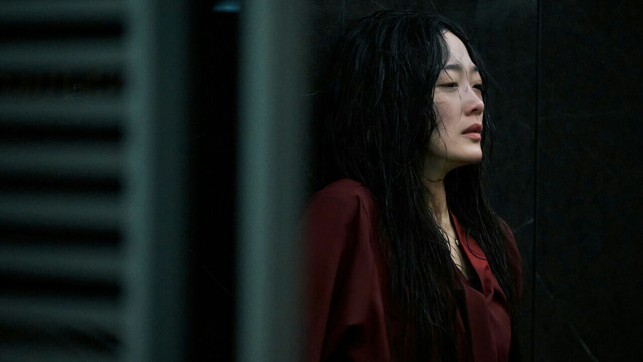 people-Asian woman-A-wet hair-A-red blouse-A-leaning against dark wall-A-dramatic lighting