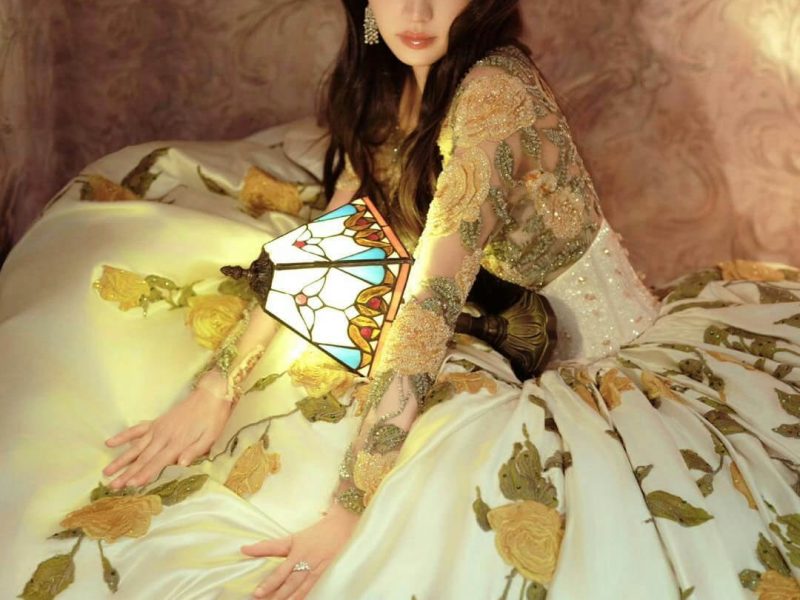 people-woman-A-elaborate gown-B-stained glass lamp-C-intricate embroidery
