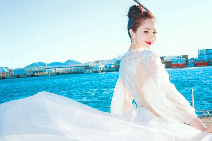 people-A-woman-A-white dress-A-outdoor-A-waterfront
