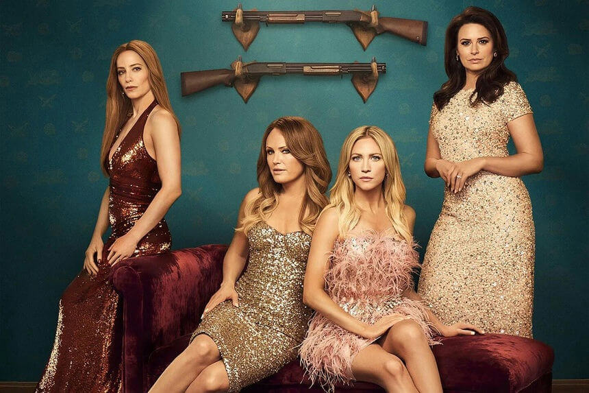 people-Four women-A-sequined dresses-A-glamorous-A-shotgun wall display-A-velvet couch