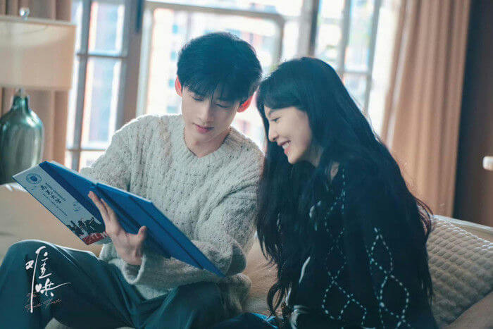 people-A-young man-A-young woman-A-looking at document-A-smiling-A-indoor setting
