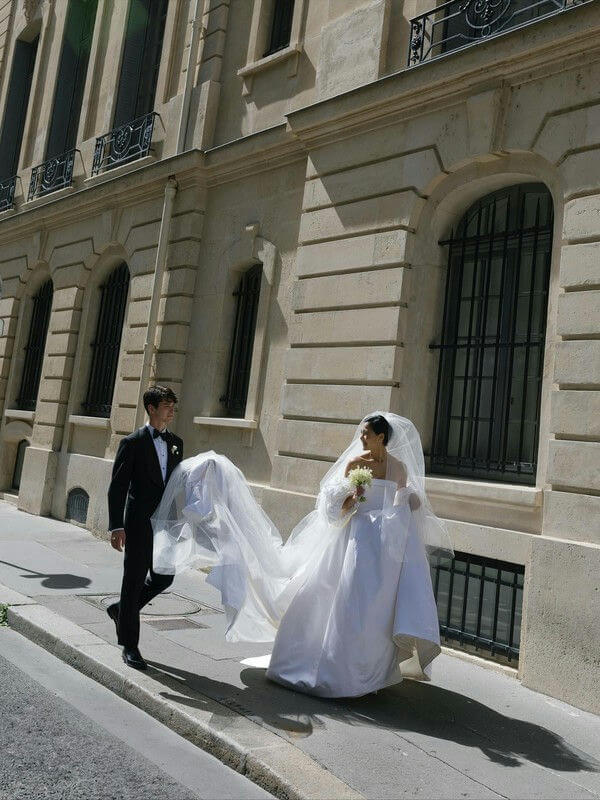 people-bride-and-groom-A-wedding-attire-A-walking-on-sidewalk-B-Parisian-street-C