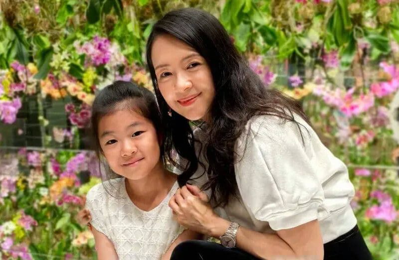 people-Mother and Daughter-smiling-indoors-floral background-casual wear-Asian descent