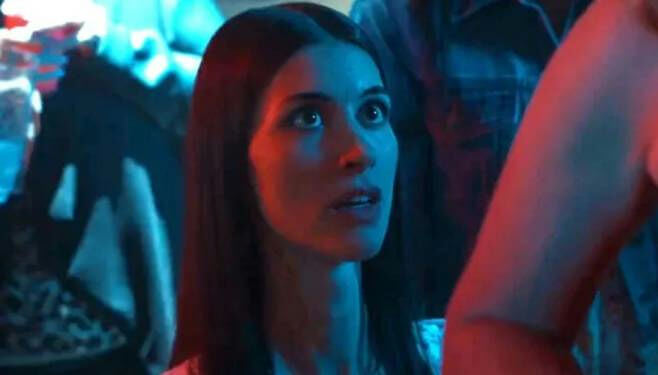 people-Woman-A-intense gaze-A-club lighting-B-crowd in background-C-close up