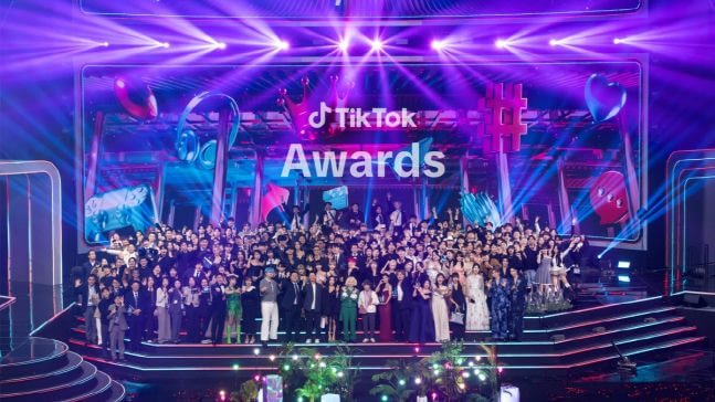 people-large group-A-stage-A-TikTok Awards sign-B-purple lighting-C
