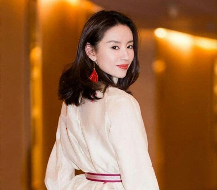 people-woman-A-looking over shoulder-B-red tassel earrings-C-white/cream top