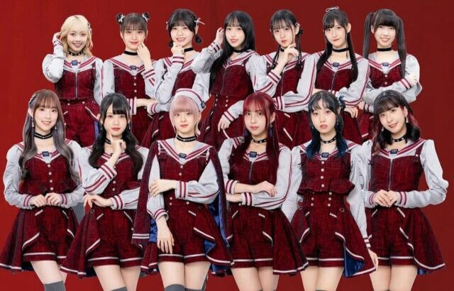 people-12 female idols-A-maroon and white sailor-style outfits-A-standing in two rows-A-red background