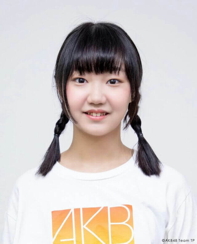 people-young woman-A-pigtails-A-smiling-A-white t-shirt-B-bangs-C