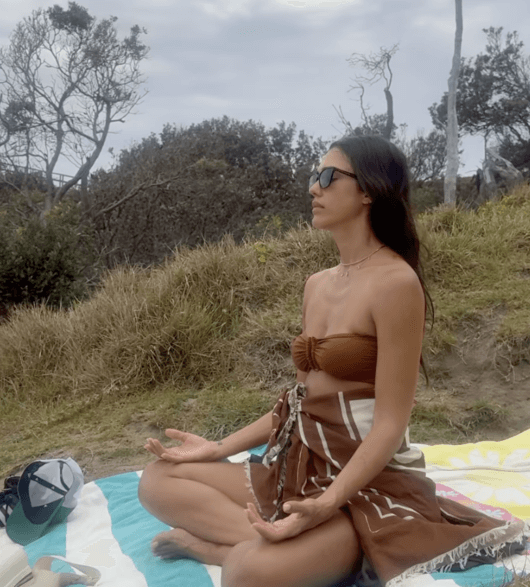 people-1-woman-A-meditating-A-outdoors-A-sunglasses