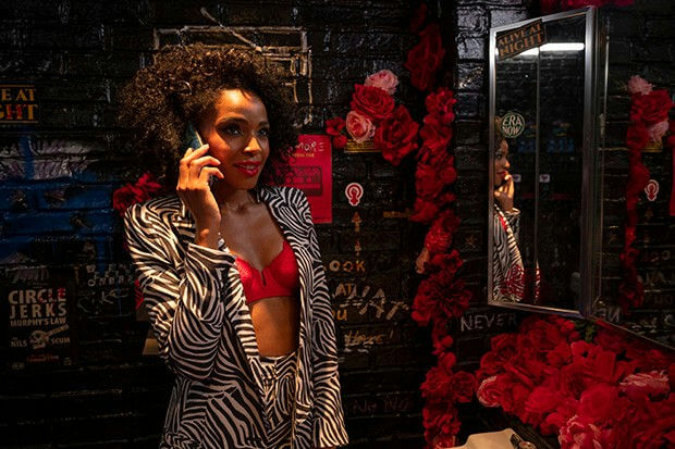 people-woman-A-talking on phone-A-zebra print outfit-B-red bra-C-dark background with red roses