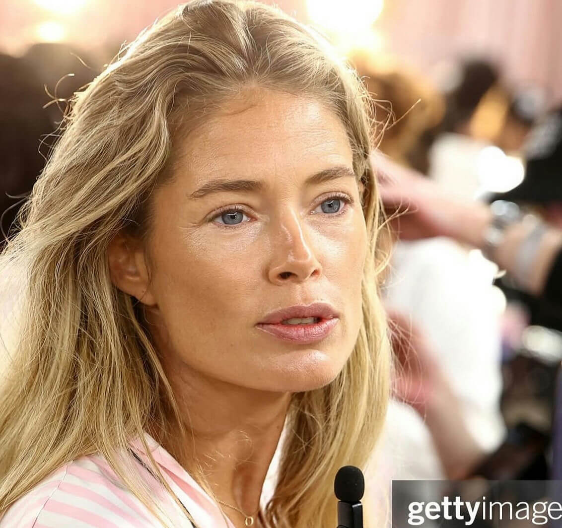 people-Doutzen Kroes-A-blonde hair-A-blue eyes-A-pink and white striped robe-A-backstage setting